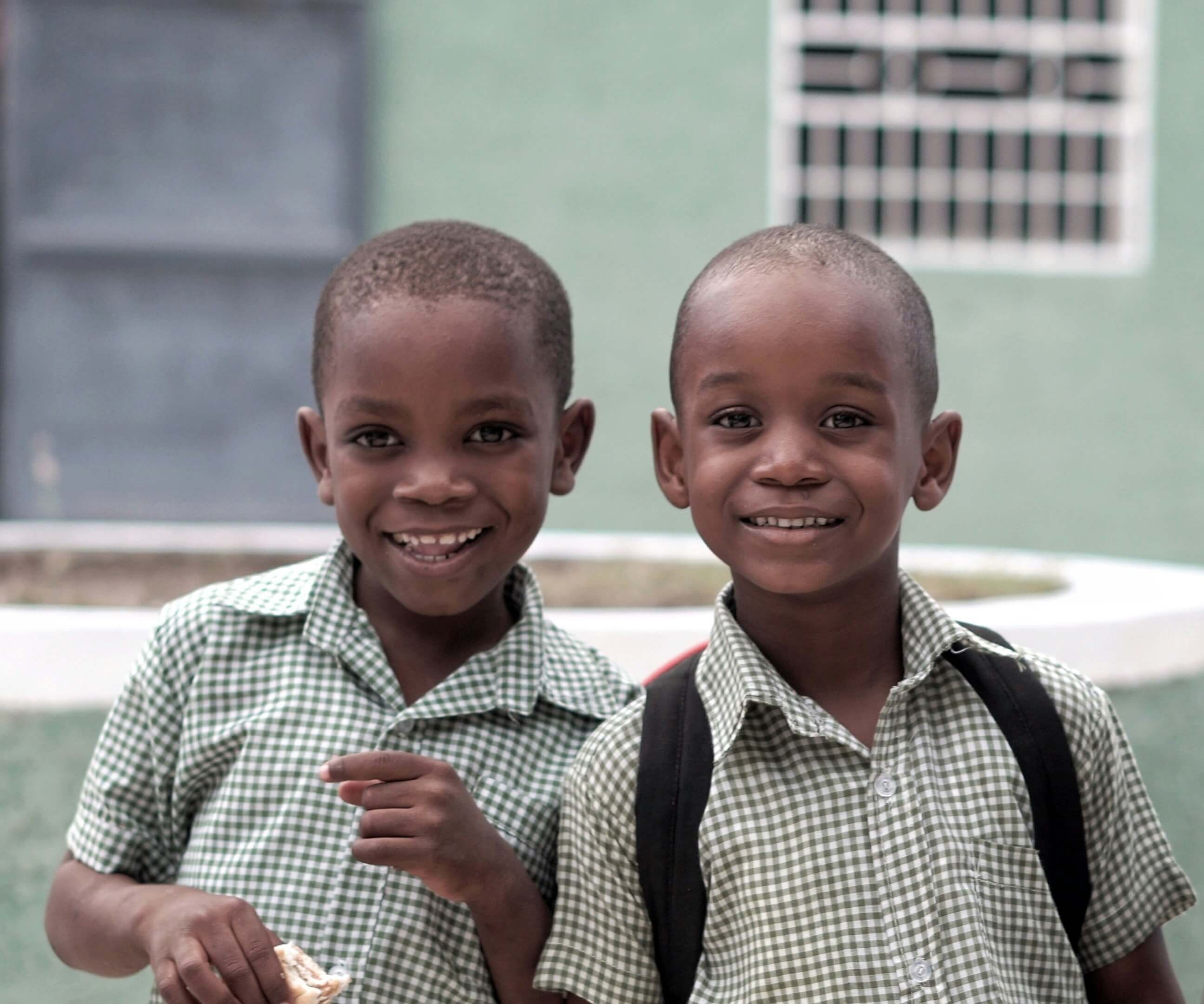 Two smiling children standing together